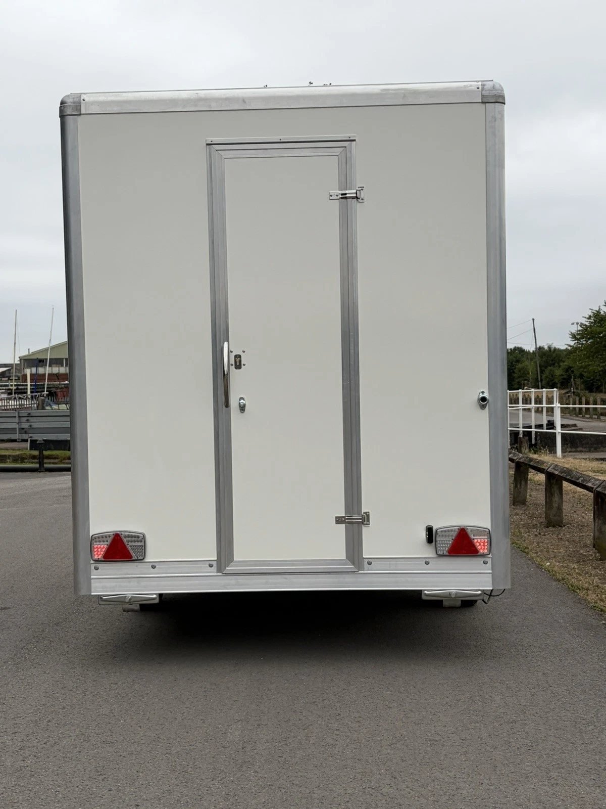 Rear of a catering trailer showing the personnel door and road lights
